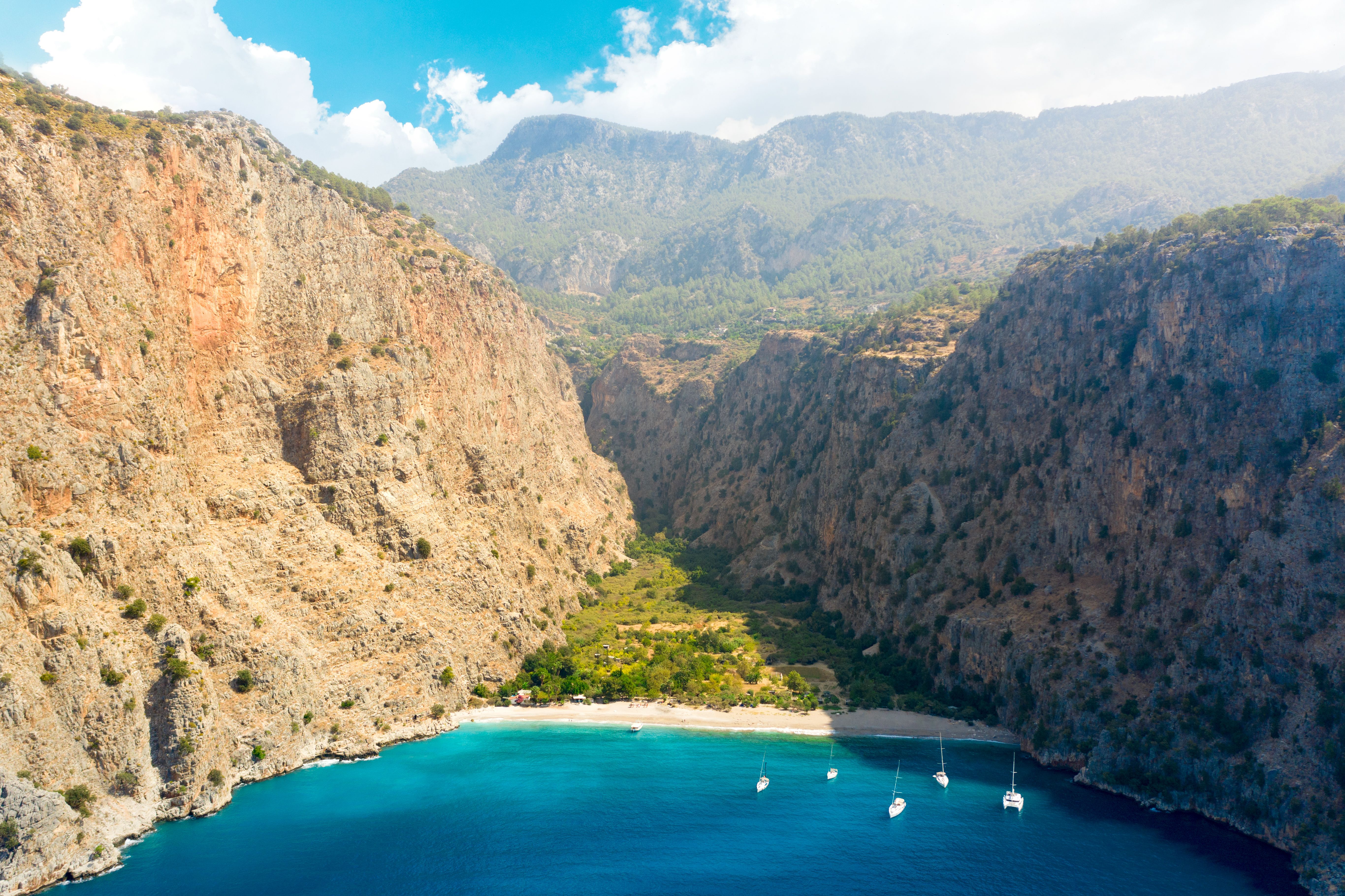 Aerial view over the clear beach and turquoise water of Butterfly Valley in Turkey