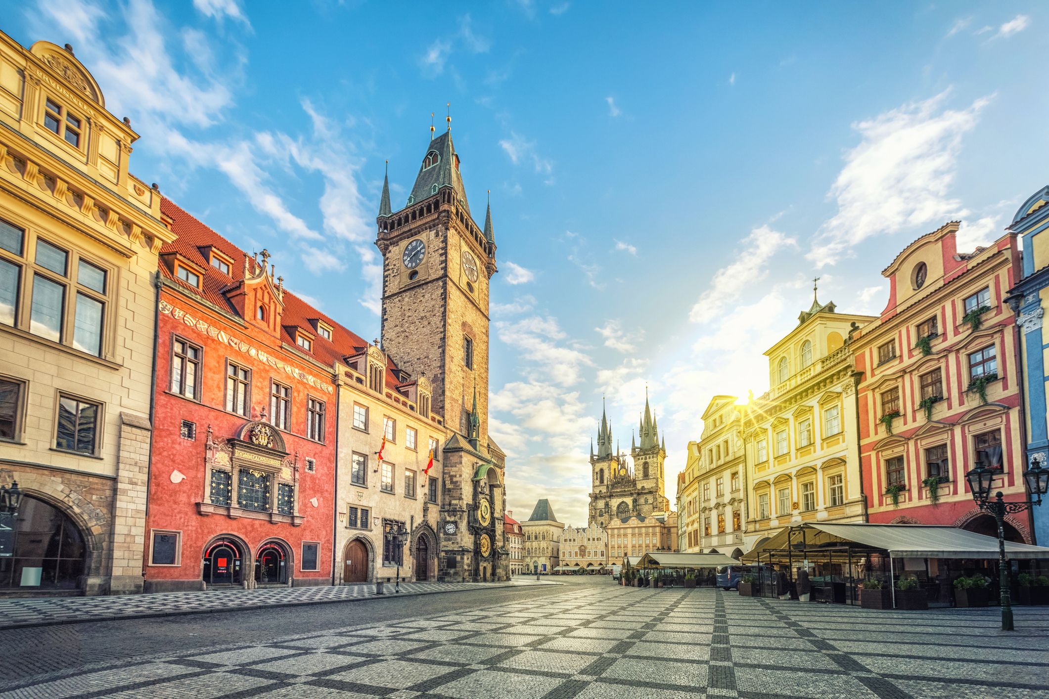 View of the Old Town square in Prague at sunrise with the clock tower and Church of Our Lady before Týn