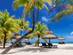 White-sand beach in Mauritius with palm trees and sun-loungers