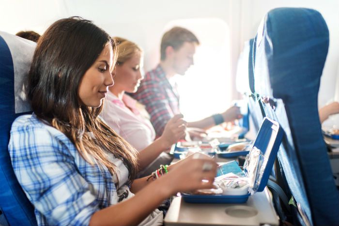 Passengers Eating On Plane