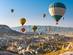 Hot air balloons flying in sunset sky over Cappadocia in Turkey