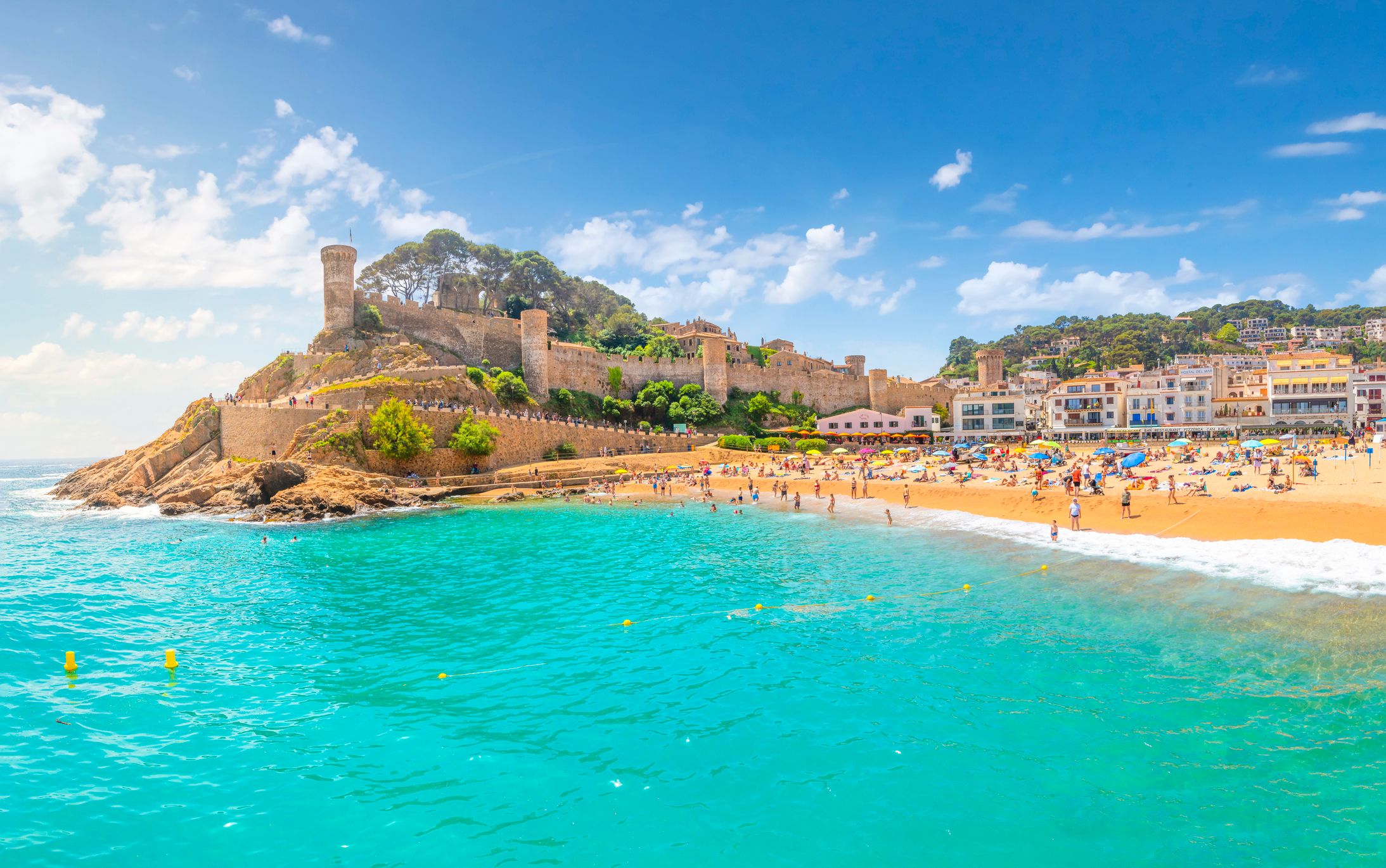 A view across the sea of Tossa de Mar beach and castle in Costa Brava