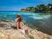 A woman and her daughter overlooking a blue bay on a family holiday