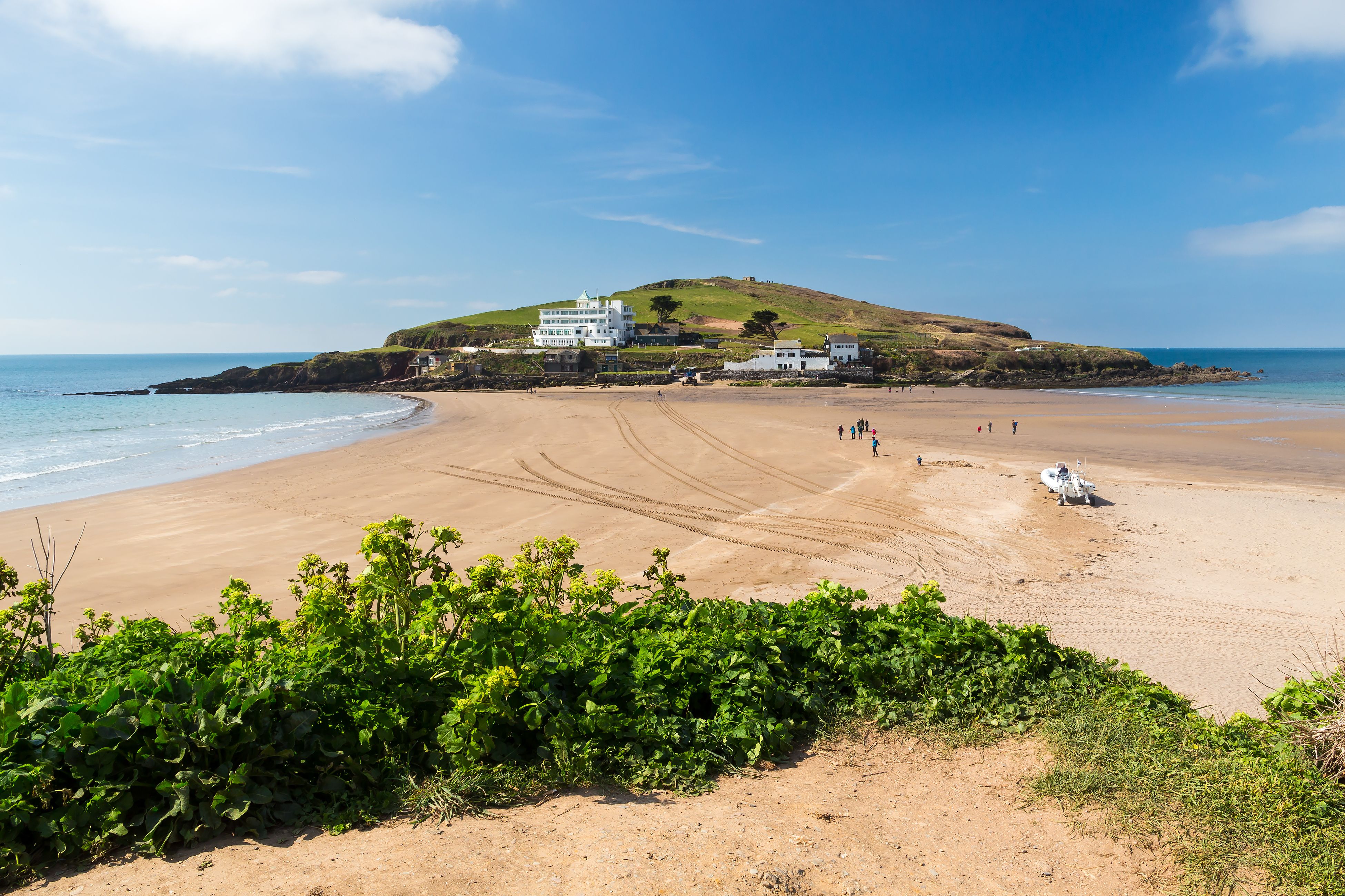 A view across the sand causeway of Burgh Island in Devon, UK