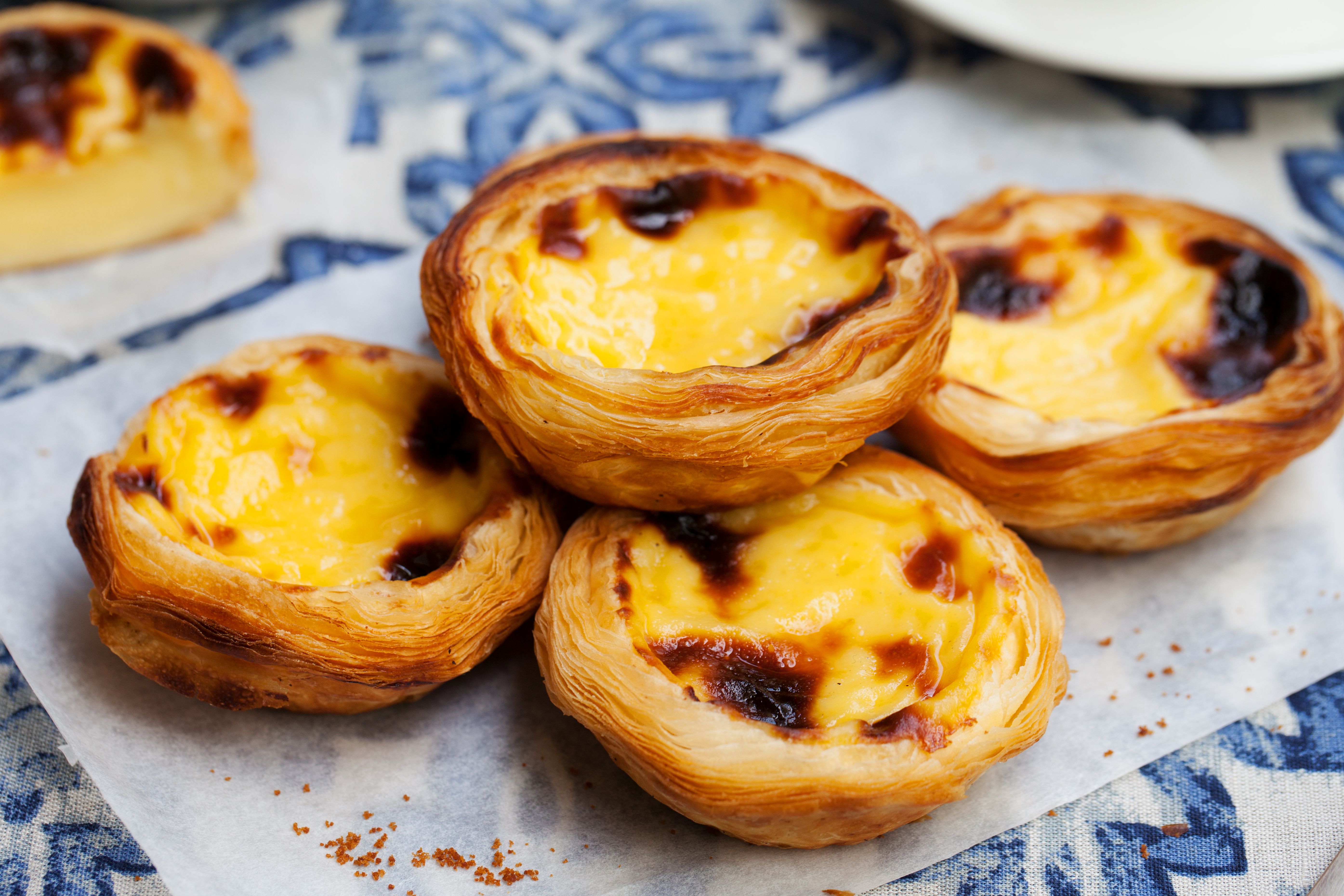 A close up of pastel de natas - traditional Portuguese custard tarts
