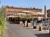 View of a café-filled plaza in front of a grand pink-brick building in Toulouse.