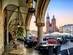 A view of the main square in Krakow old town with cafe tables and chairs and a dusky sky