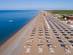 A view of sun loungers and umbrellas on a beach in Belek, Turkey on a clear blue day