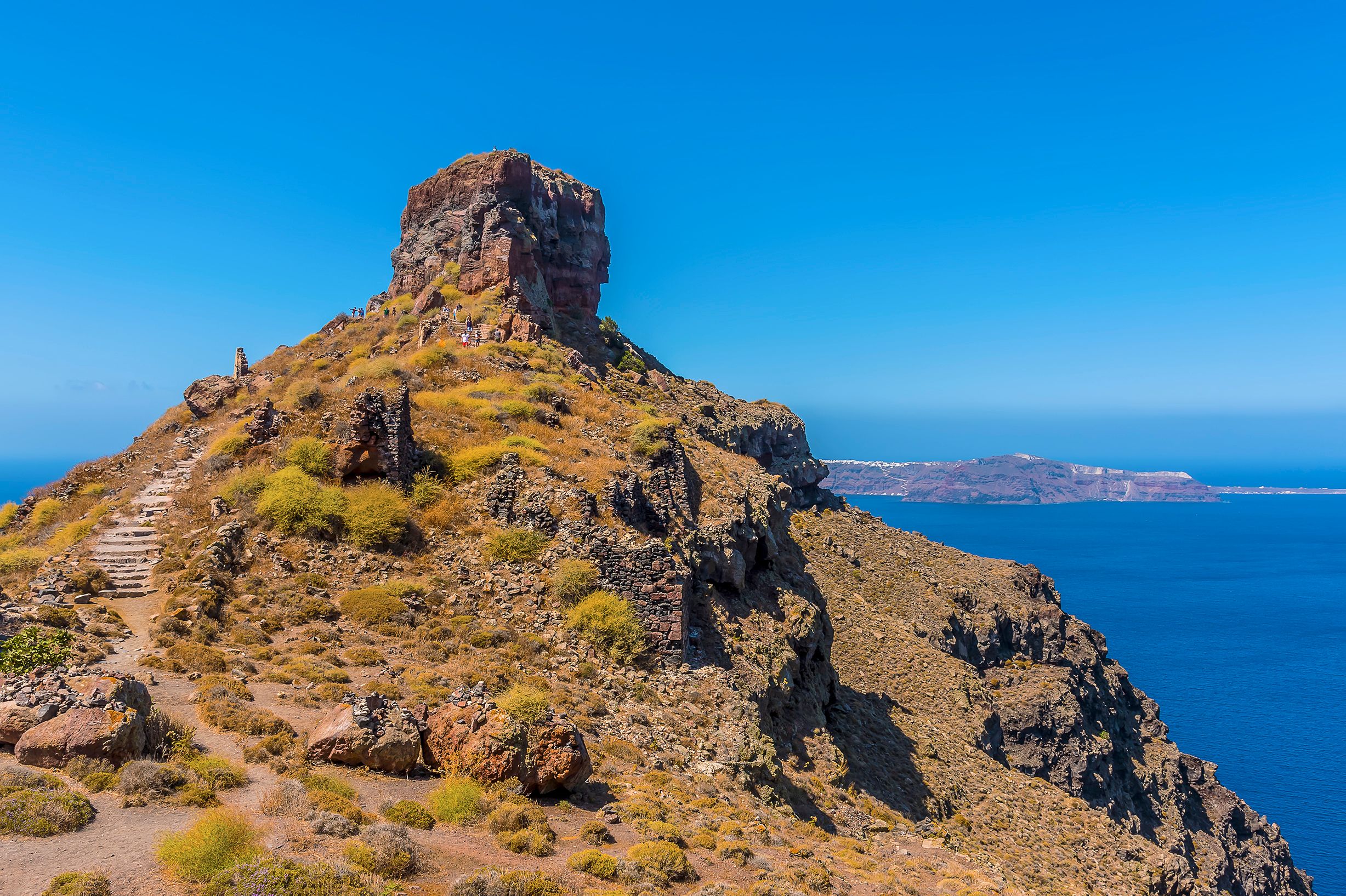 Stone stairs lead up to an old clifftop fort overlooking the blue Mediterranean