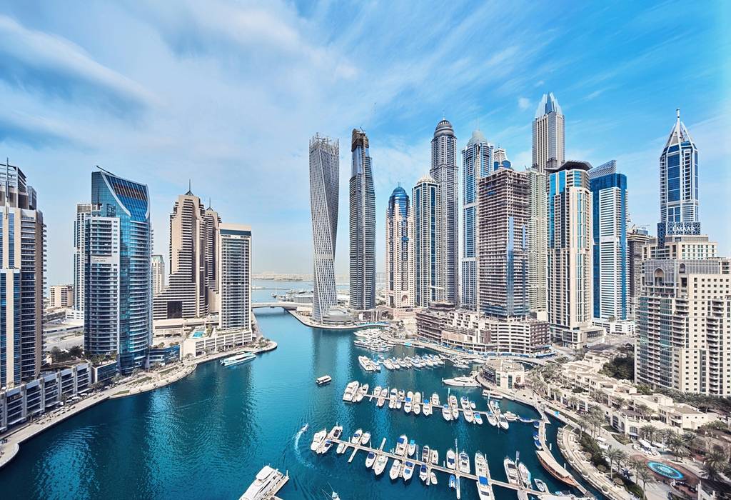 View of the skyscrapers and yachts of Dubai Marina on a sunny day