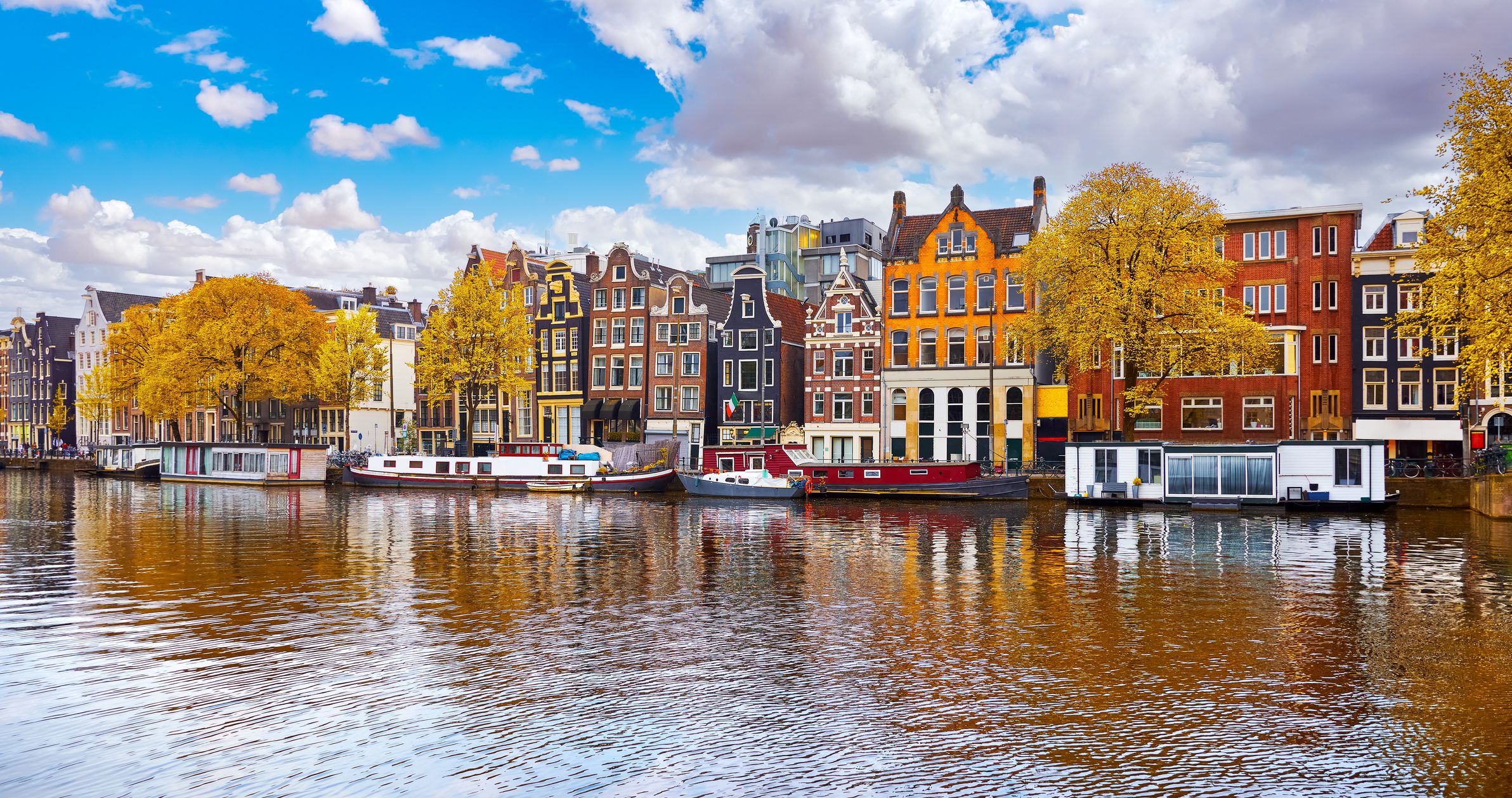 A view of colourful houses along a canal on an autumn day in Amsterdam