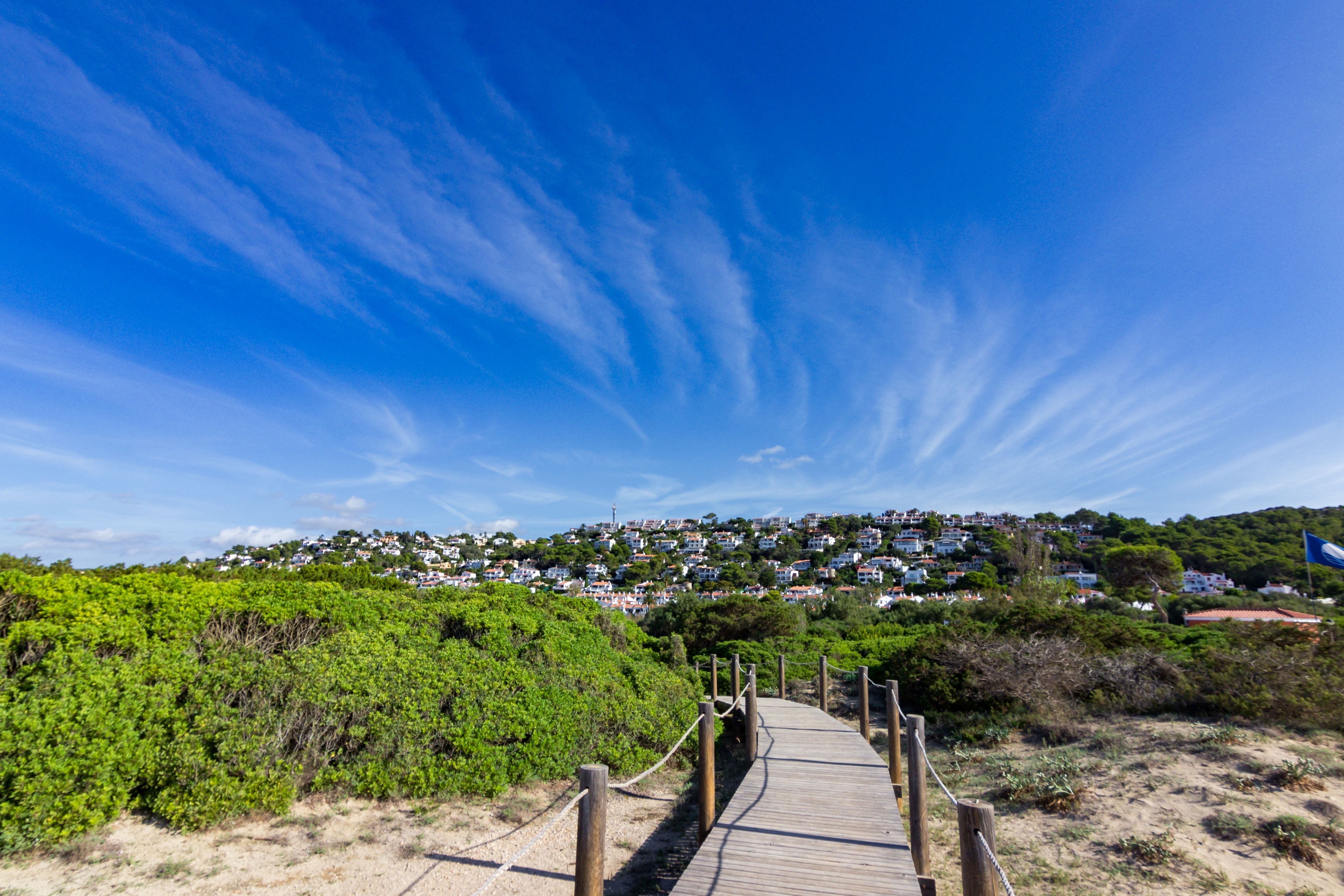 View of a beach walkway leading to Son Bou resort in Menorca, Balearic Islands