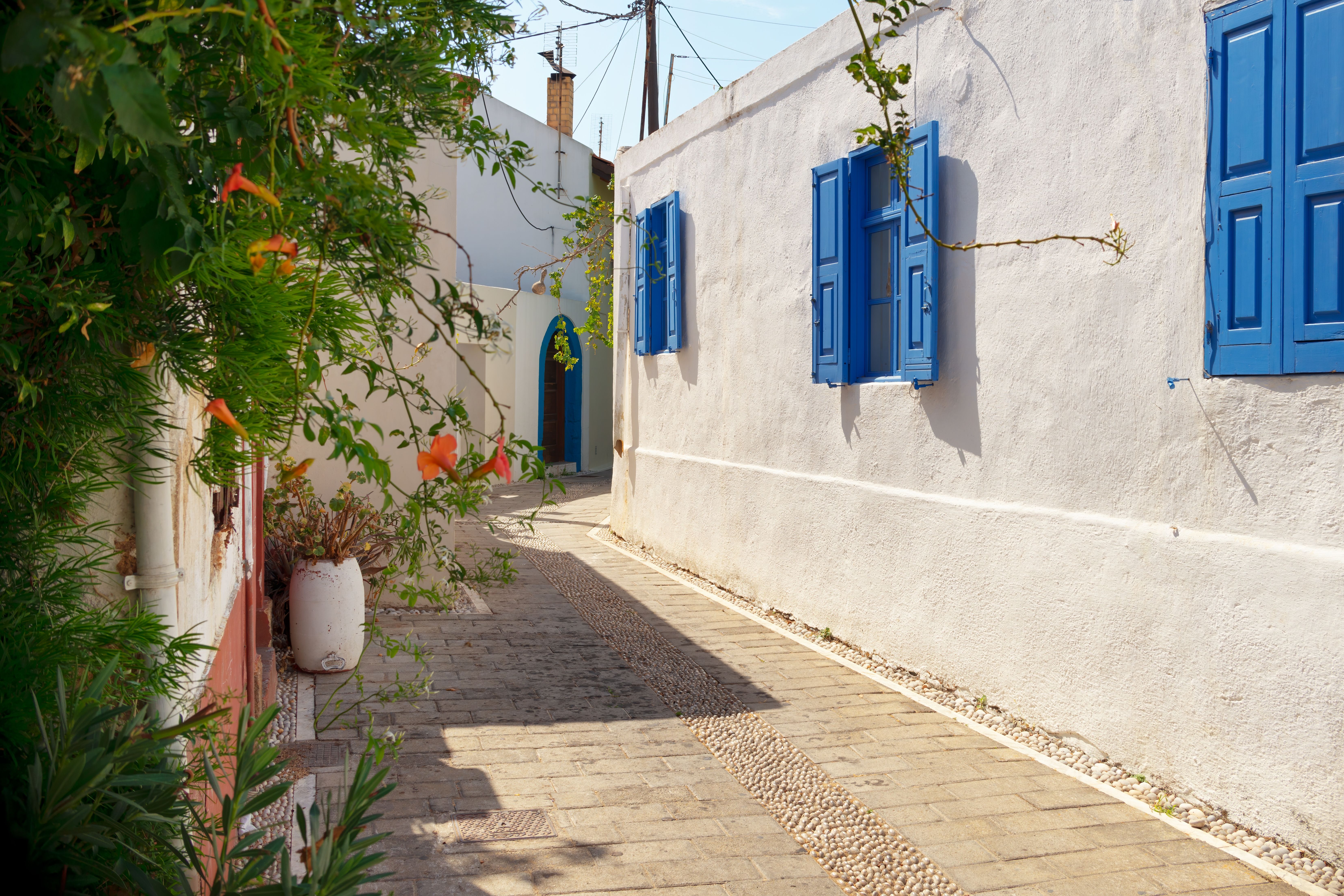 A traditional street with blue shutters in Koskinou, Rhodes, Greece