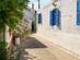 A traditional street with blue shutters in Koskinou, Rhodes, Greece