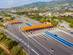 An aerial view of cars passing through a road toll point in Spain
