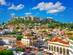 A view of Plaka in downtown Athens, Greece, with the Parthenon atop the Acropolis in the background on a sunny day