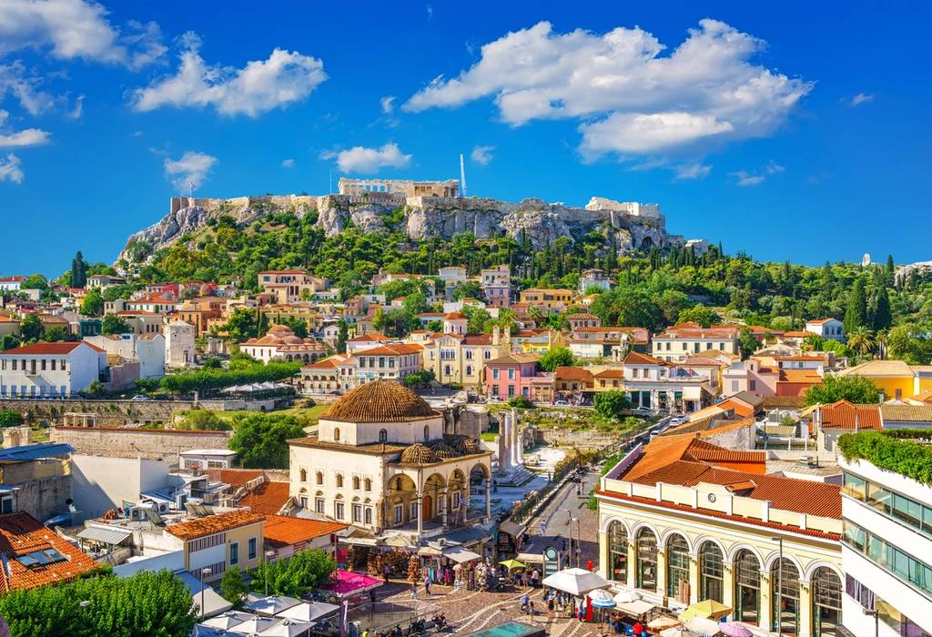A view of Plaka in downtown Athens, Greece, with the Parthenon atop the Acropolis in the background on a sunny day