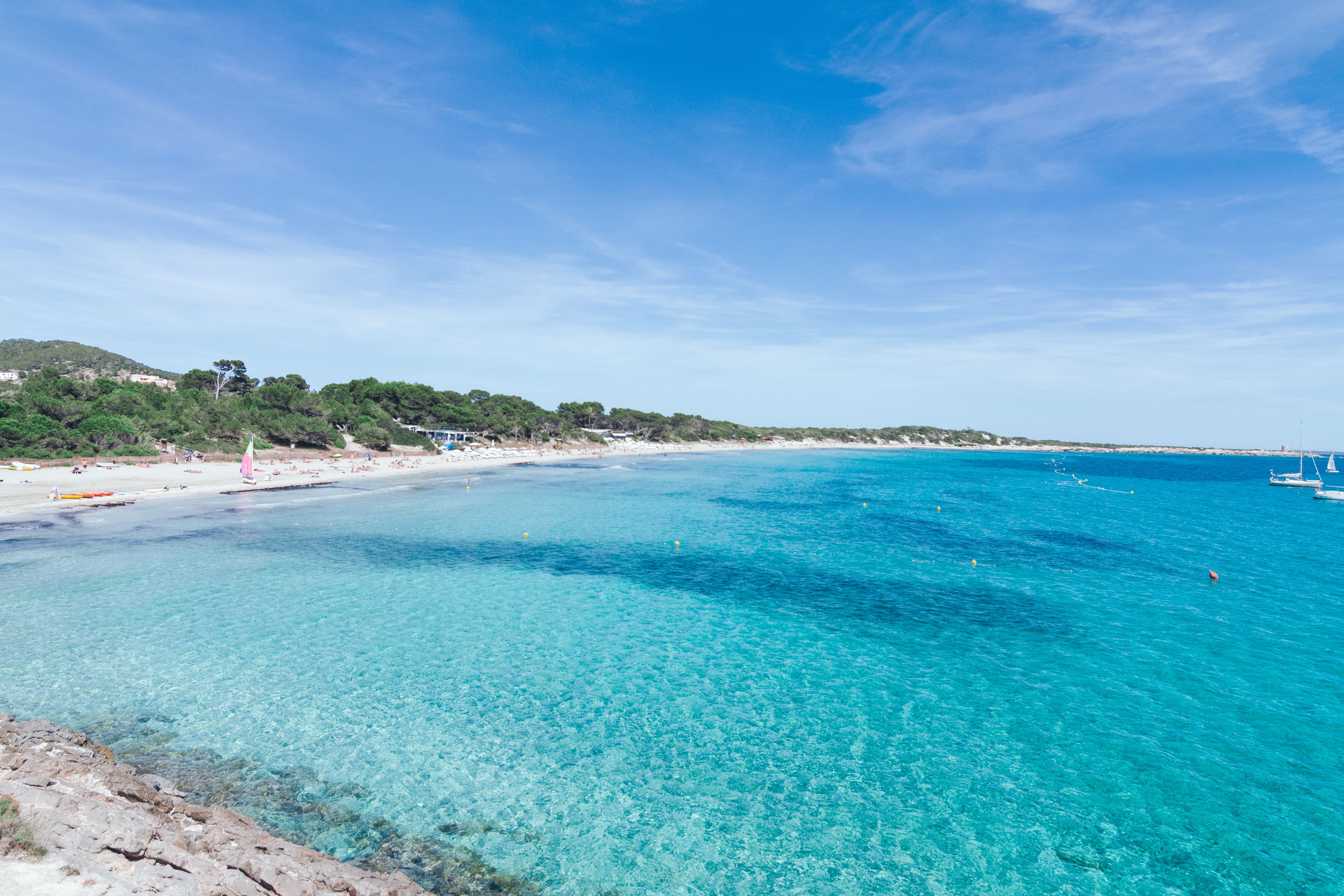 View of the stunning clear waters and the white sand of Las Salinas beach Ibiza in Spain