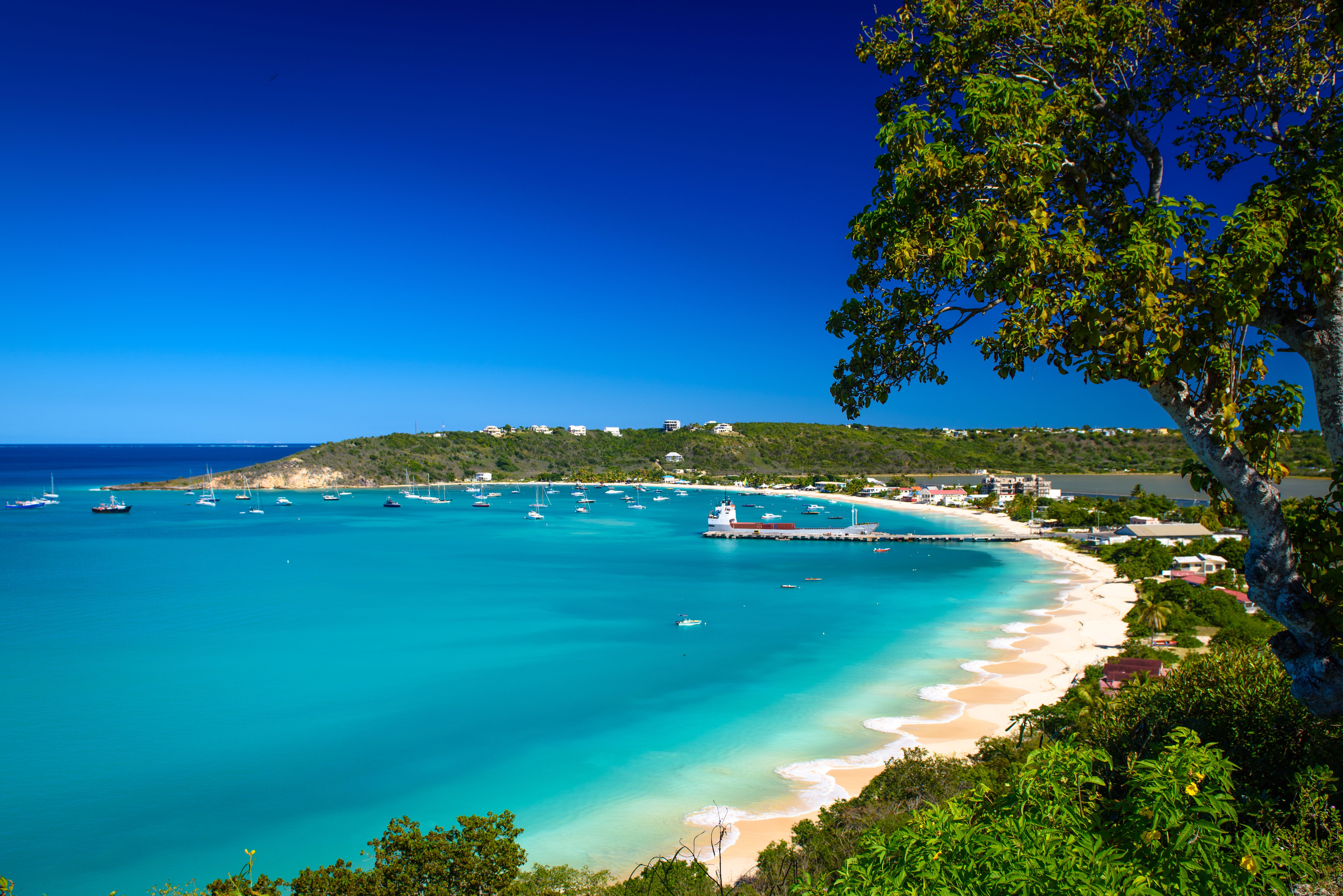 A view of a white sandy beach in Anguilla, the Caribbean with turquoise blue sea