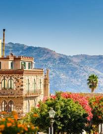 A view of Sicilian houses and a bell tower in the town of Taormina