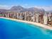 An aerial view of Benidorm coast, Spain with skyscrapers lining the beach and bright blue sea