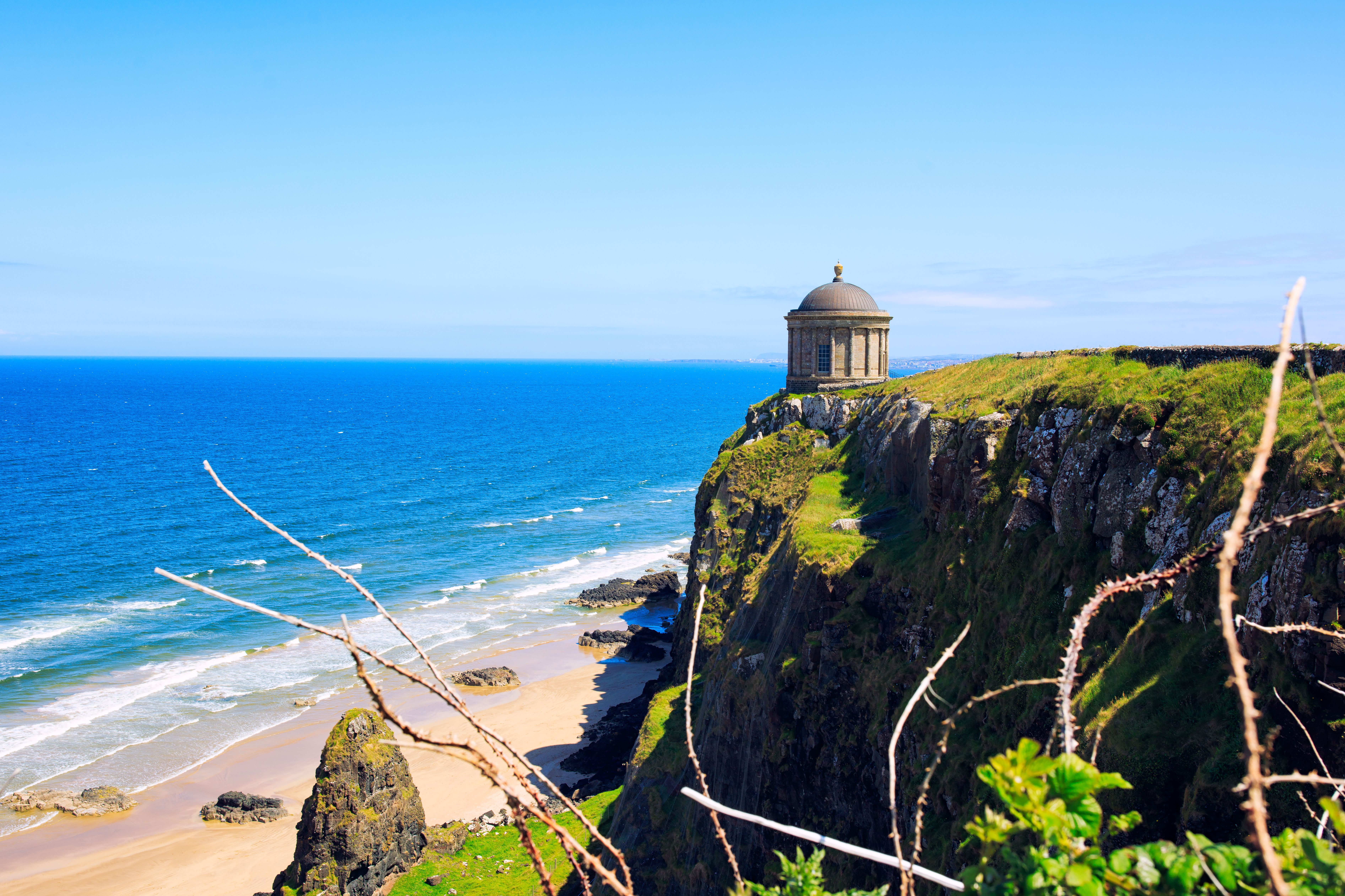 Overlooking the golden stand and temple-topped cliff of Downhill Strand, Northern Ireland