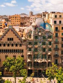 Aerial view of a street in Barcelona with the famous Casa Batlló with its fantastical facade that features bone-shaped columns and balconies