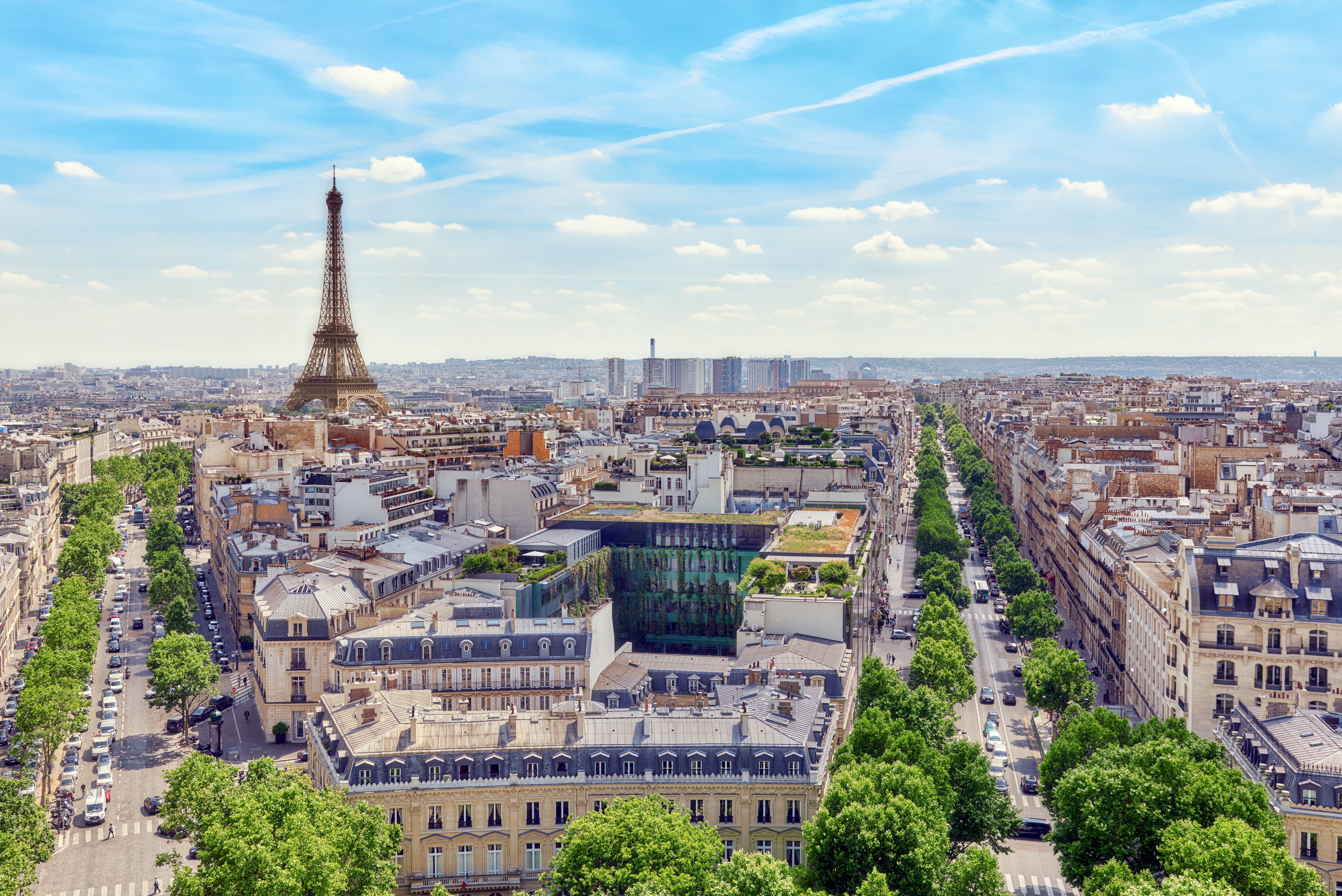 An aerial view of Paris city with the Eiffel Tower on a bright blue day