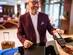 A businessman checking out from hotel and making a contactless payment with his credit card