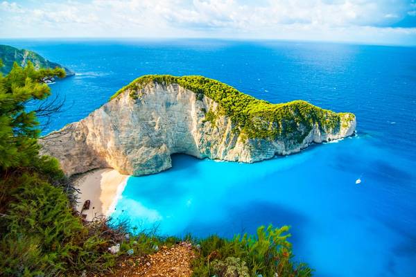 An aerial view of the iconic shipwreck on Navagio beach in Zante, Zakynthos, Greece on a sunny day