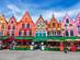 The colourful, stepped gable buildings lined with restaurant and cafe tables in Bruges' central square