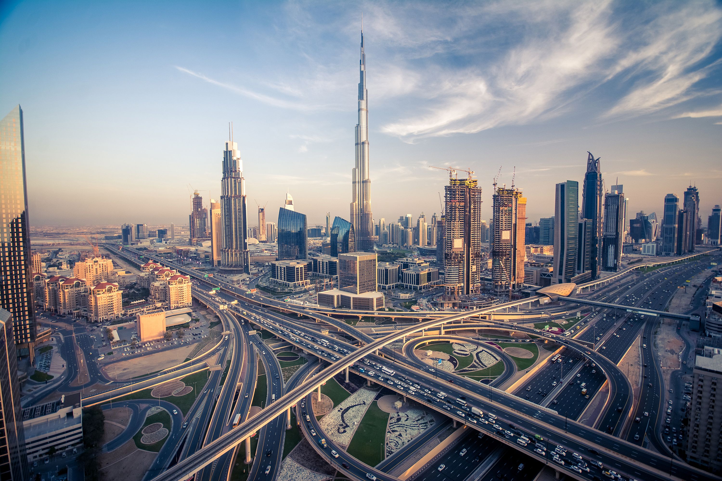 View of the Burj Khalifa skyscraper with the looping, busy roads of Dubai's highway in the foreground