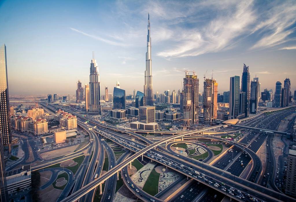 View of the Burj Khalifa skyscraper with the looping, busy roads of Dubai's highway in the foreground
