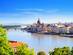 A cityscape view during a summer sunset showing the Hungarian Parliament Building and Danube river in the historical center of Budapest, Hungary