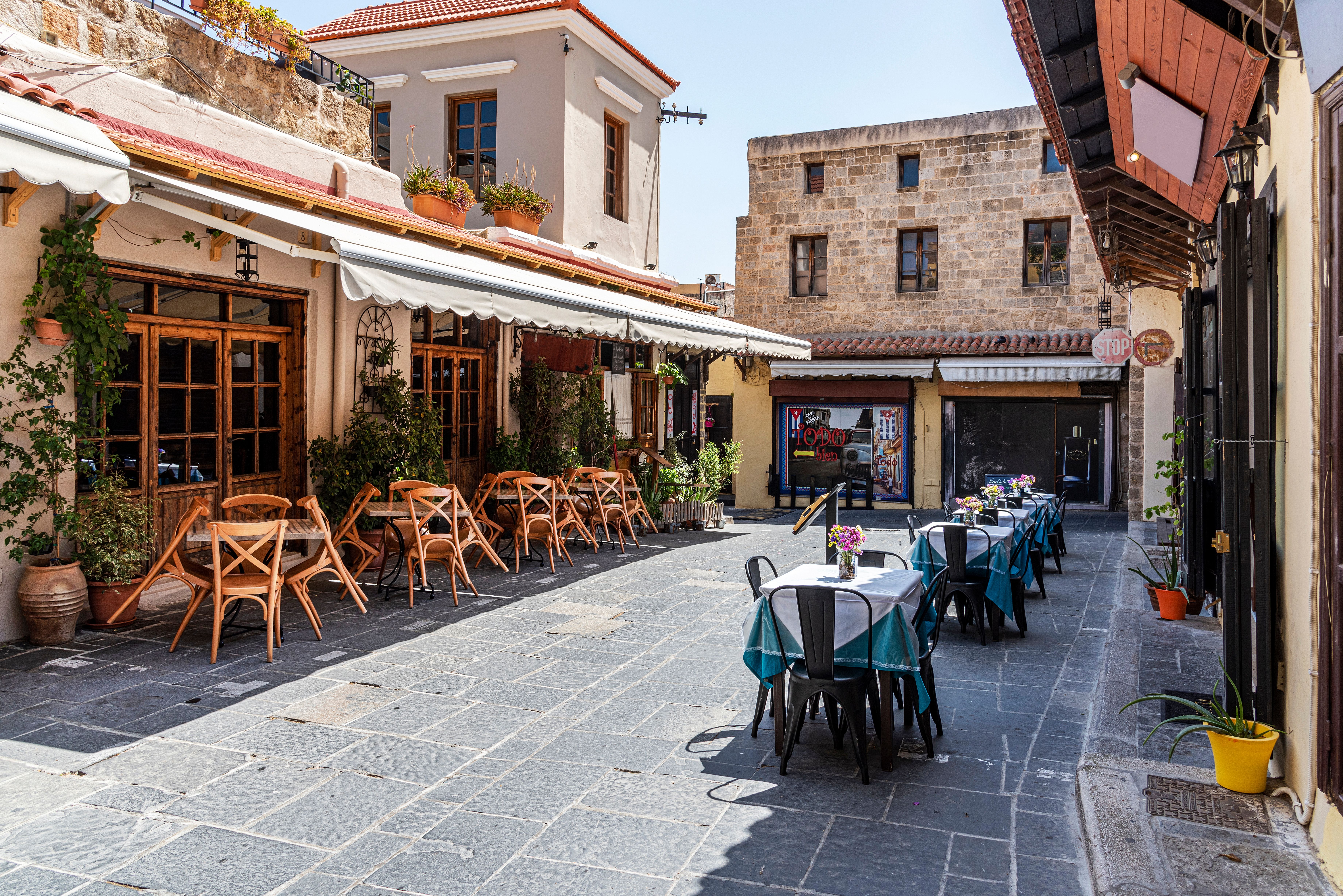 Restaurants in a courtyard in Rhodes Old Town, Greece