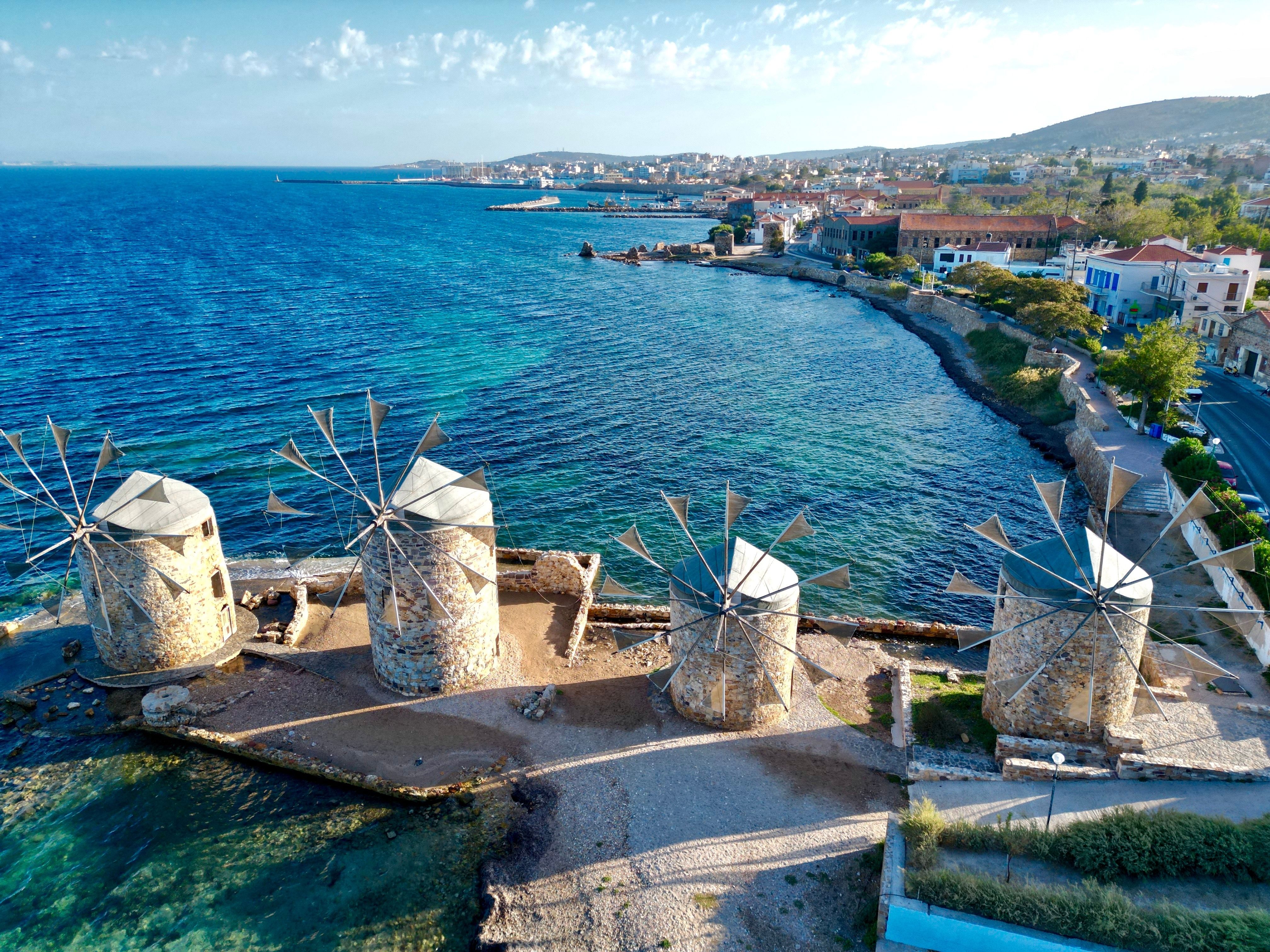 A view of Chios Island in Greece with traditional stone windmills on the waterfront