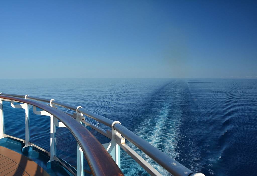 A picture showing the wake of a cruise ship in the sea on a clear sunny day