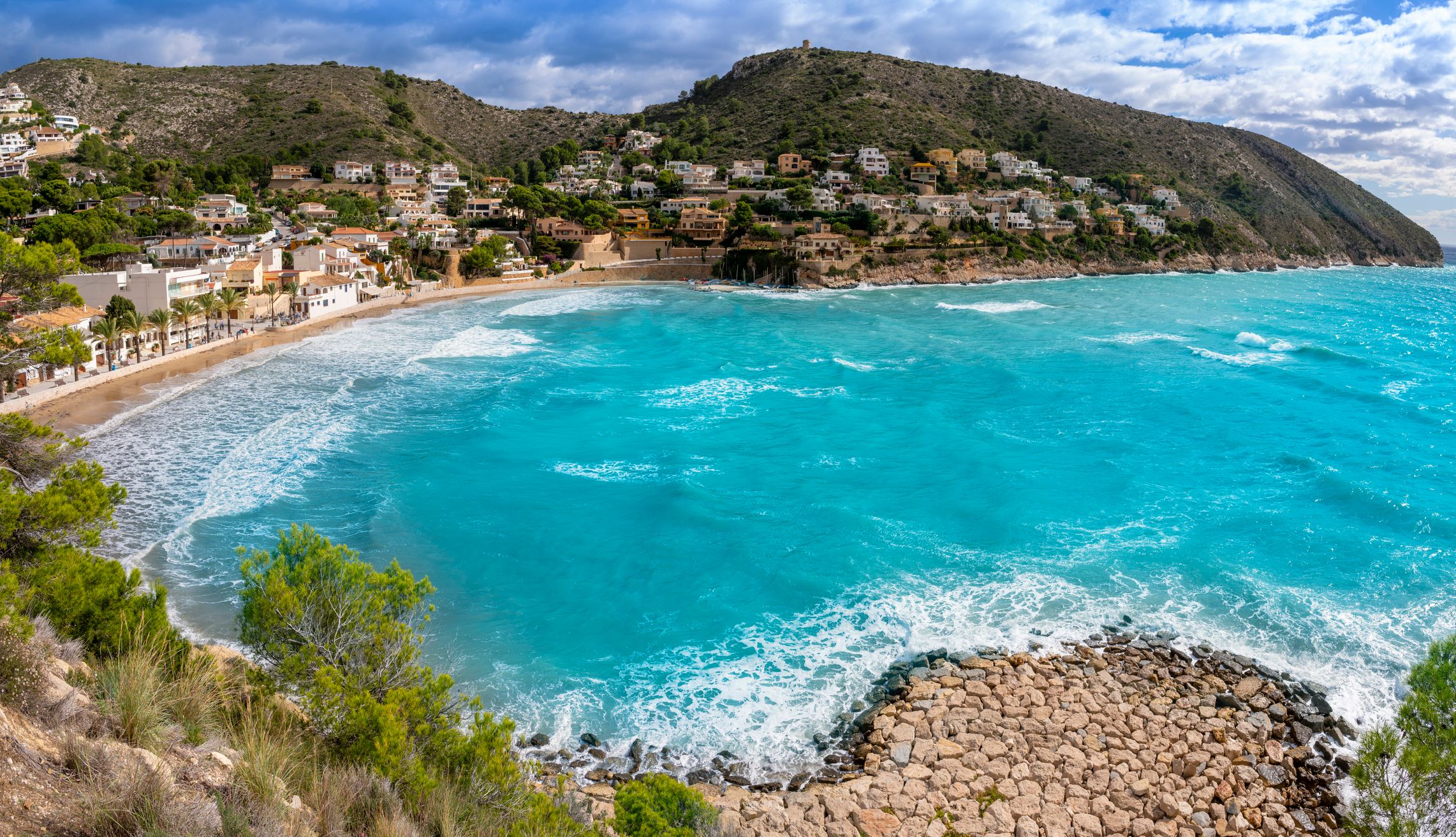 A view of Cala El Portet beach in Moraira, a small coastal town in Costa Blanca, Spain