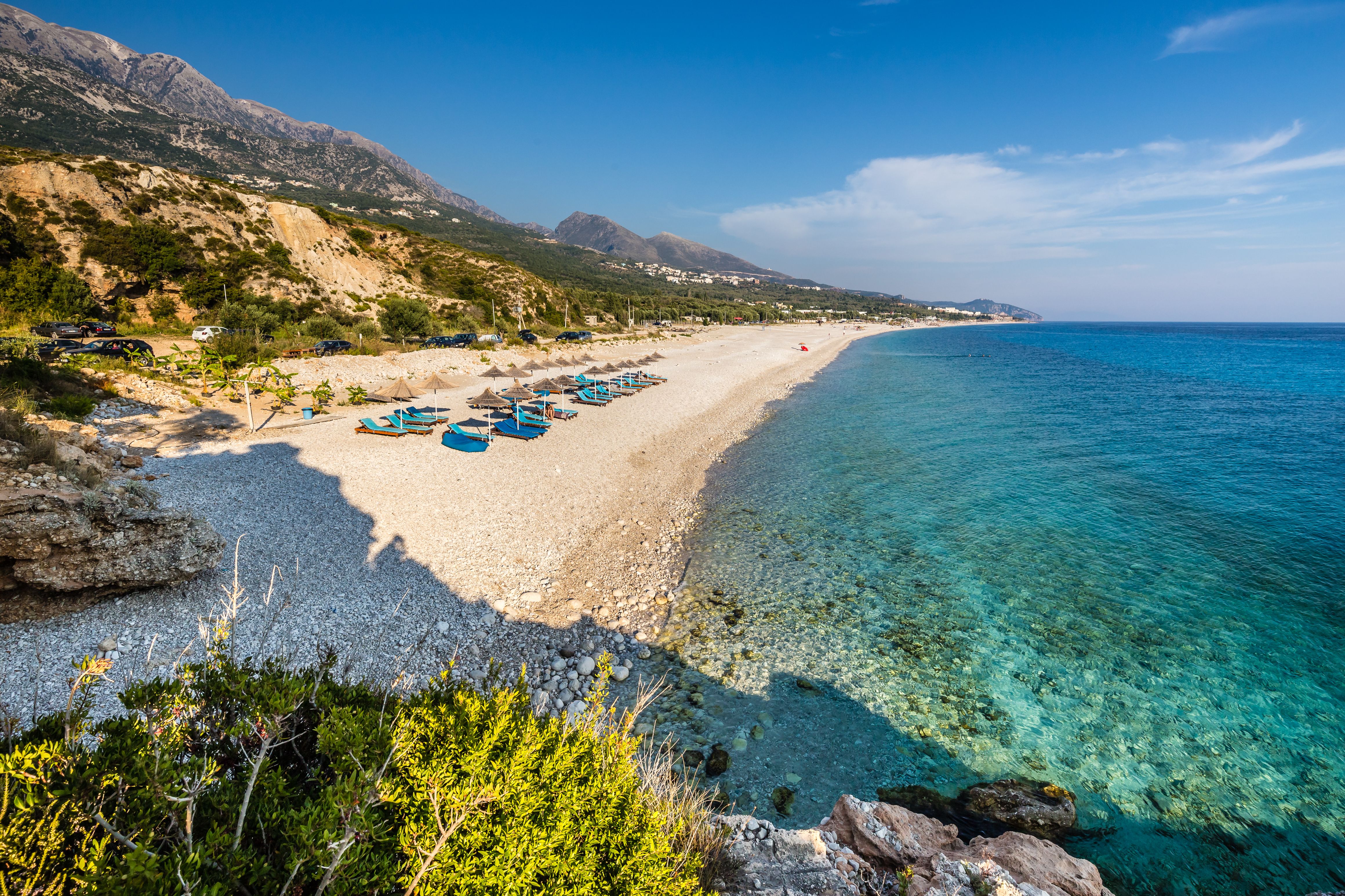 Sunbeds and umbrellas on Dhermi Beach in Albania