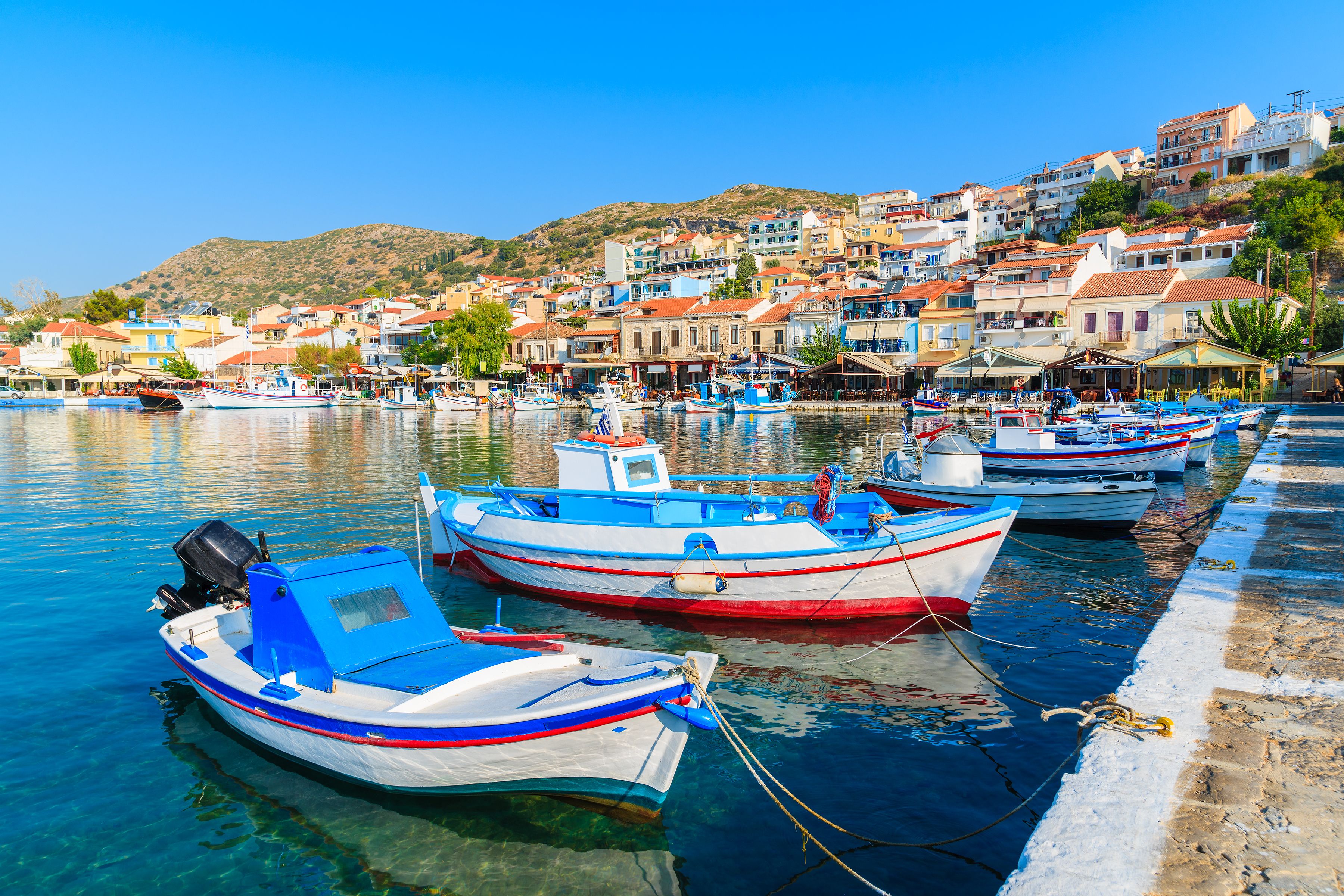 Traditional colourful Greek fishing boats in Pythagorion port, Samos island, Greece