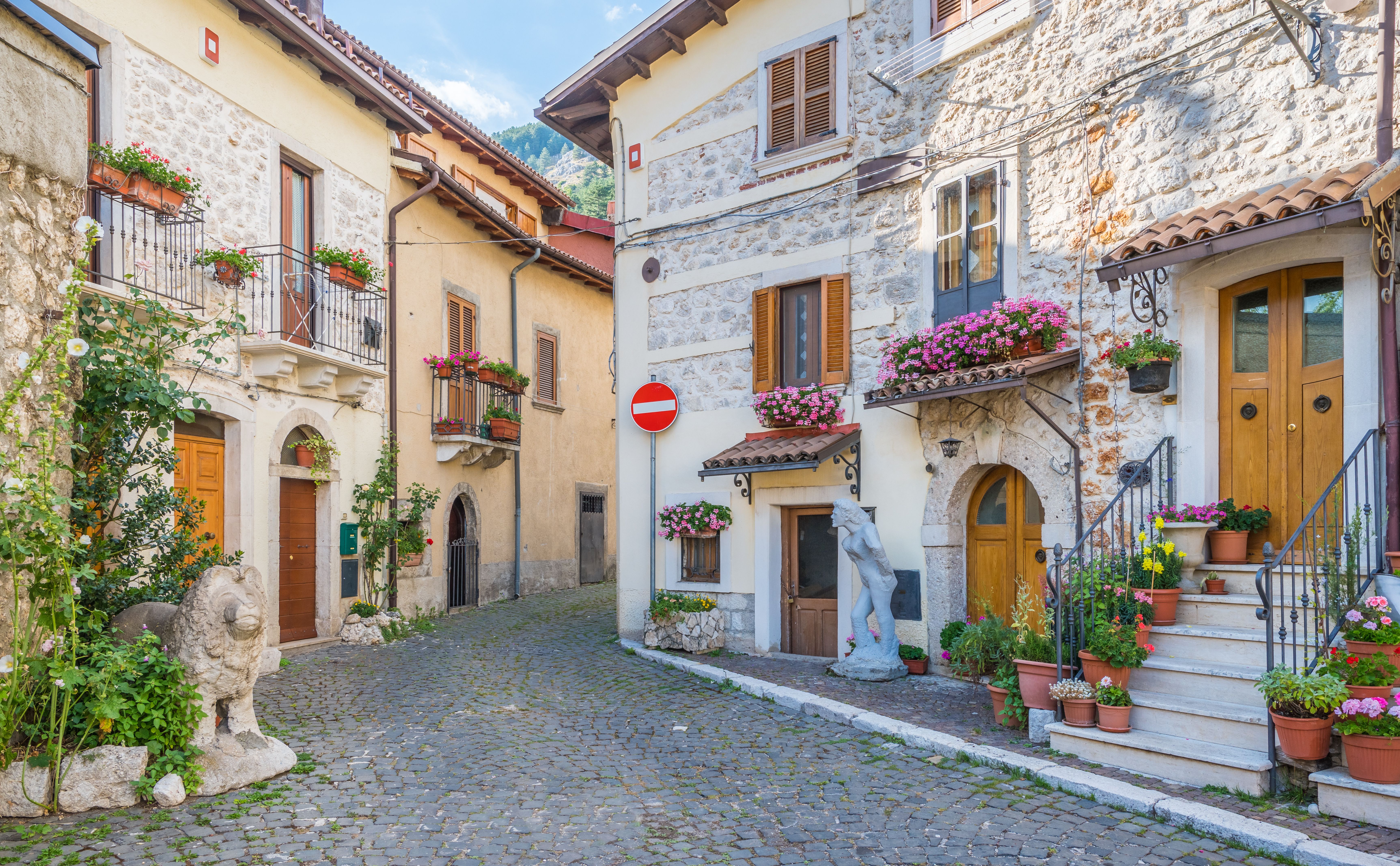 View of stone houses with flower boxes in the windows and teak-coloured doors and shutters