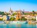 River cruise boats along the Danube River with the colourful buildings and churches of Buda in the background