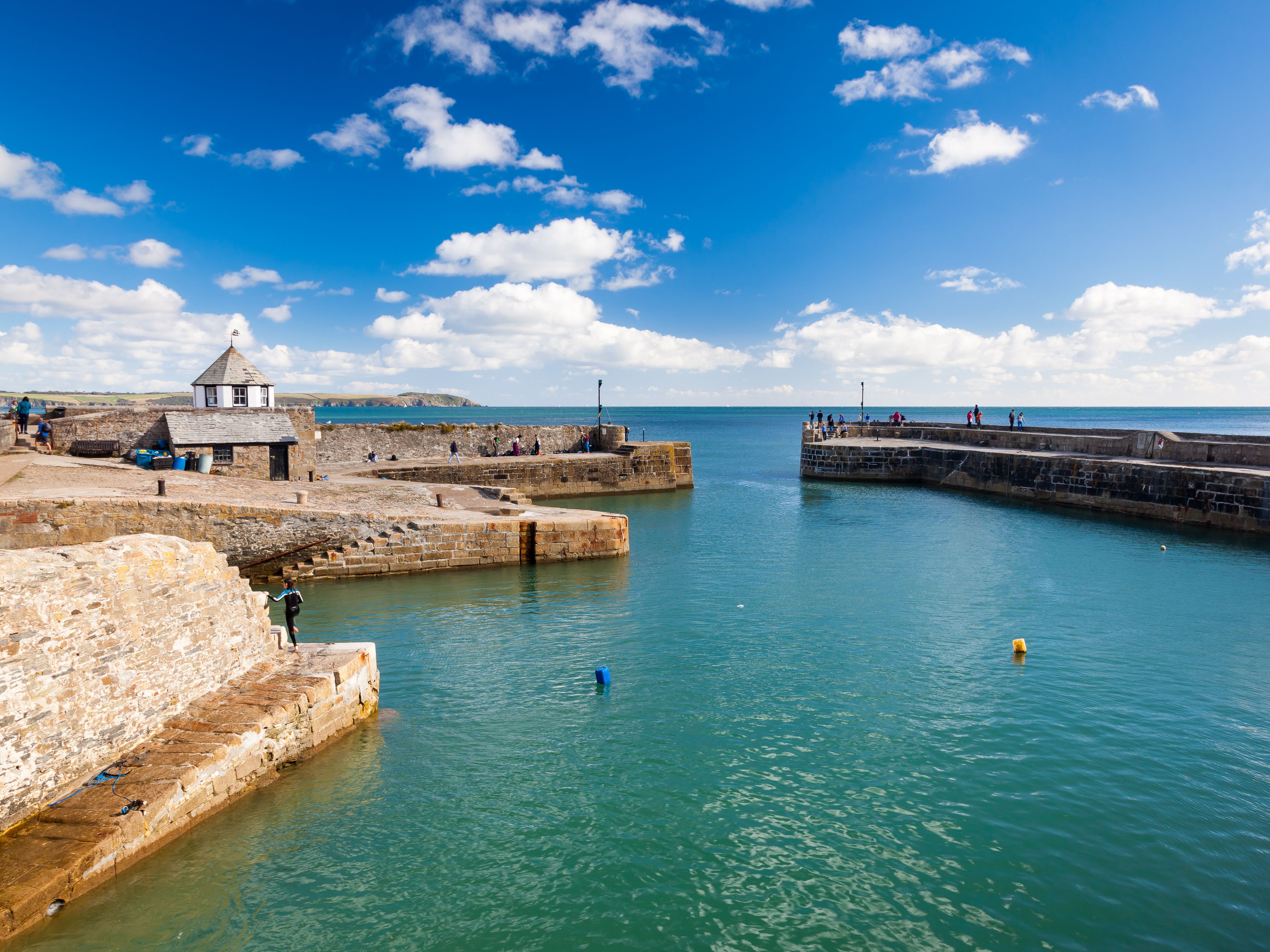View of a small harbour with two buoys bobbing in the water.