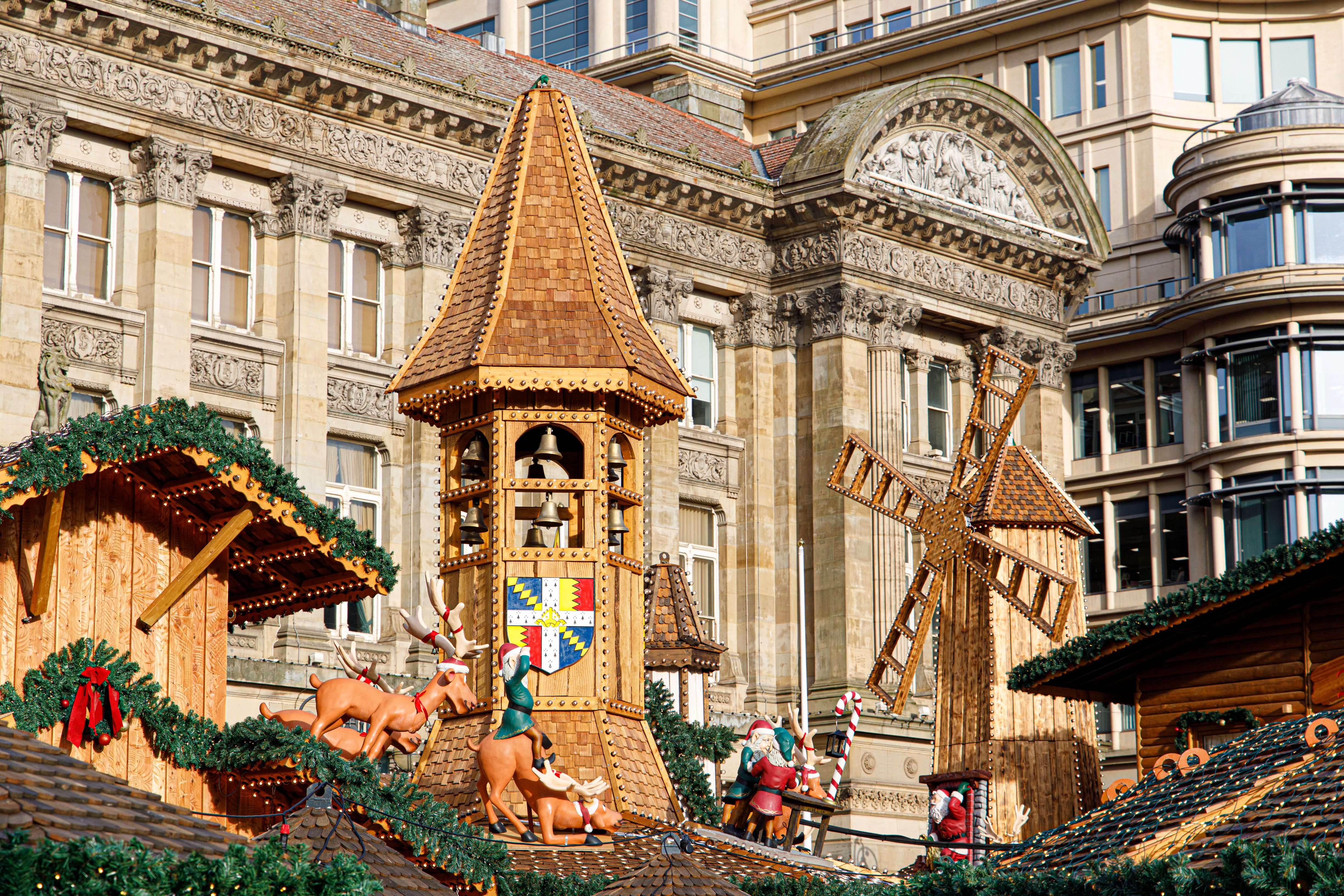 A close up of the market stall rooftops at Birmingham Christmas market decorated with reindeer figures and garlands