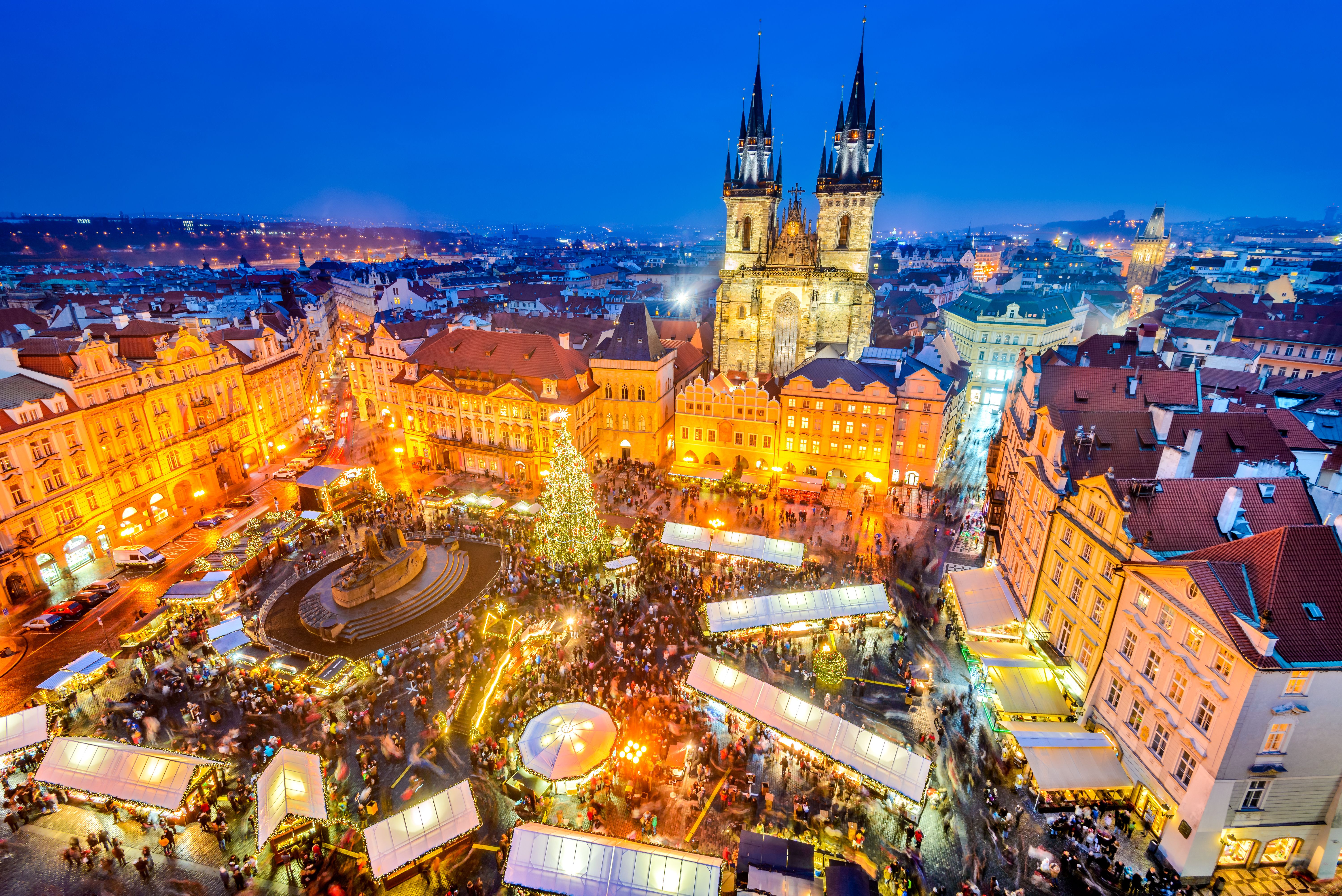 Aerial view of Prague Christmas market in the Old Town square with brightly lit stalls and attractions