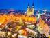 Aerial view of Prague Christmas market in the Old Town square with brightly lit stalls and attractions