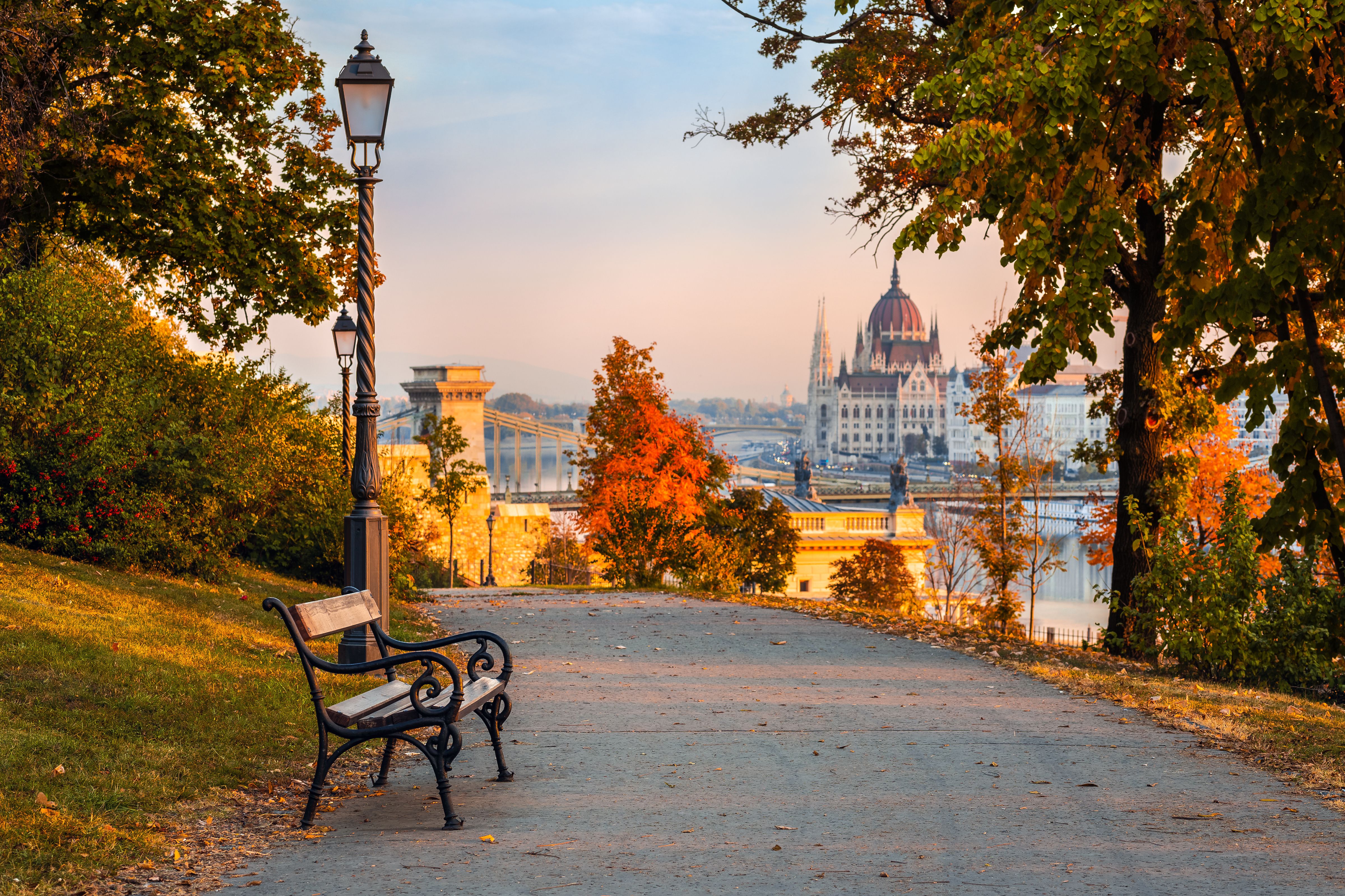 Early morning view of a park path looking out towards Budapest's Szechenyi Chain Bridge and Parliament Building