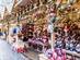 Christmas ornaments and stuffed toys such as reindeer and santas fill the wooden stalls of a Christmas market in Manchester, England