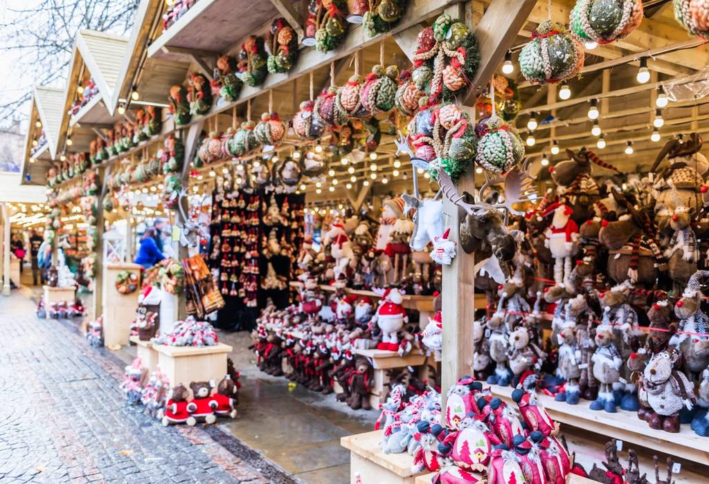 Christmas ornaments and stuffed toys such as reindeer and santas fill the wooden stalls of a Christmas market in Manchester, England