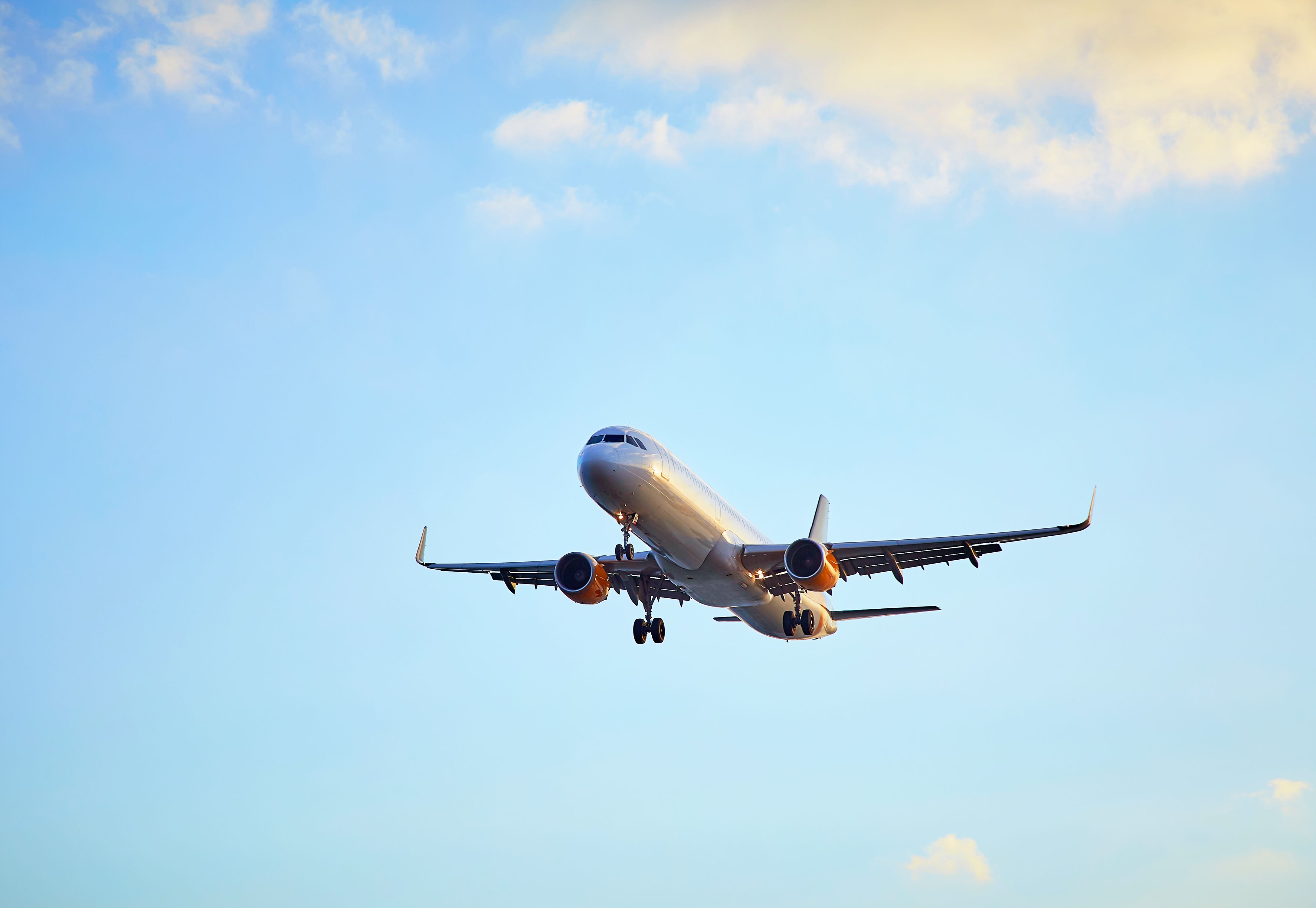 Plane flying at sunset